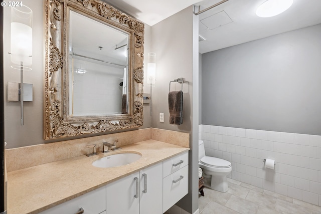 333 NW 9th Ave Unit 1205, Portland, OR 97209 - full bathroom featuring toilet, tile patterned floors, vanity, and a shower