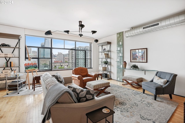 333 NW 9th Ave Unit 1205, Portland, OR 97209 - living area featuring a chandelier, a city view, and light wood-style floors