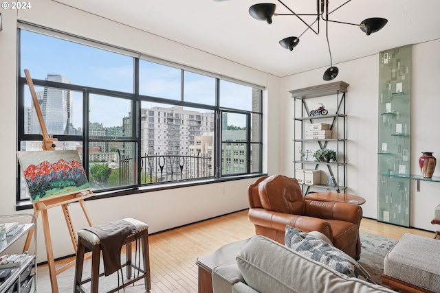333 NW 9th Ave Unit 1205, Portland, OR 97209 - living room with a city view, wood finished floors, and a chandelier
