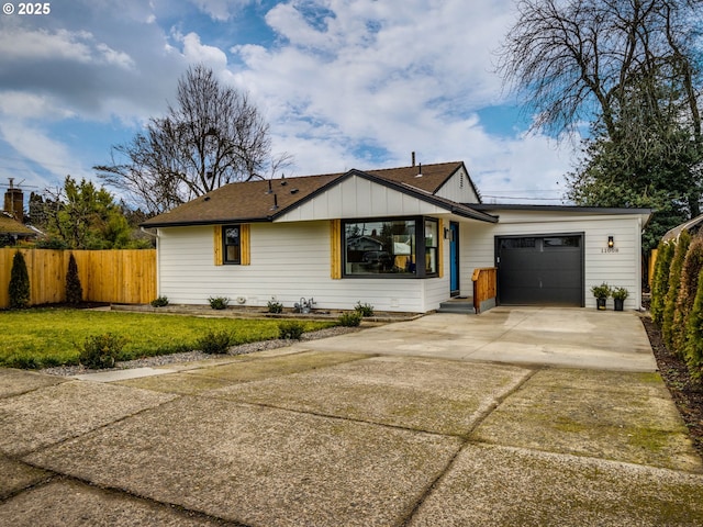 view of front of house with a garage and a front lawn