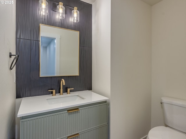 bathroom with toilet and vanity