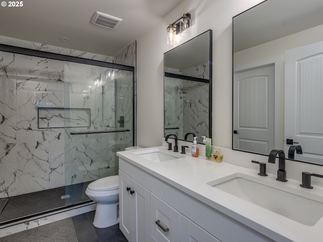 bathroom featuring tile patterned flooring, toilet, a shower with door, and vanity