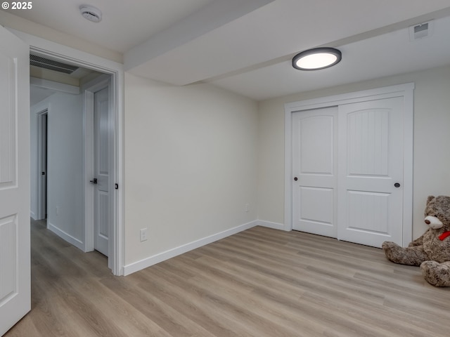 unfurnished bedroom featuring a closet and light wood-type flooring