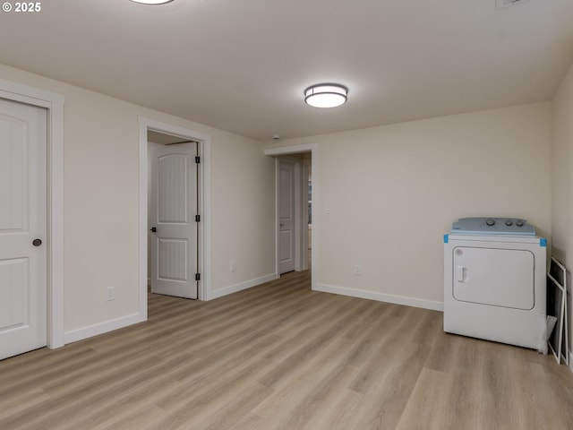 washroom with light hardwood / wood-style floors and washer / clothes dryer