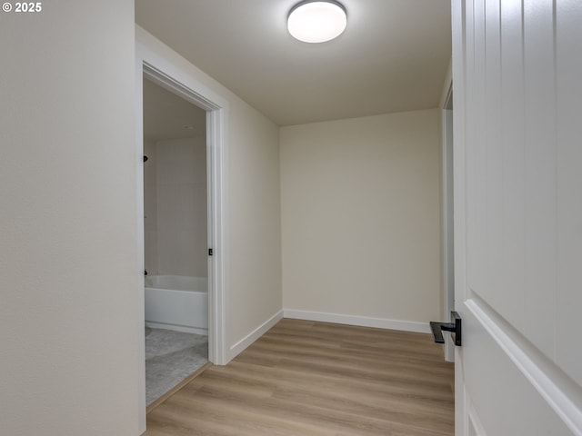 corridor with light hardwood / wood-style flooring