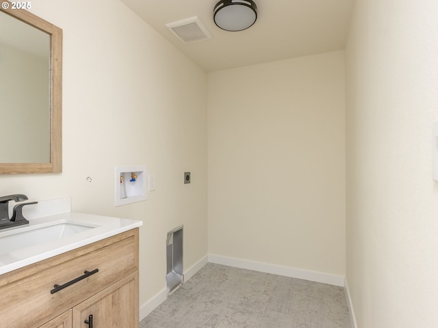 laundry room with hookup for an electric dryer, hookup for a washing machine, and sink