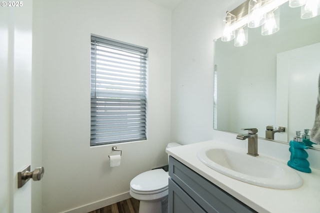 213 SE 1st Ave, Battle Ground, WA 98604 - half bathroom featuring toilet, vanity, and wood finished floors