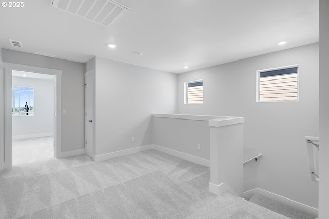 below grade area featuring recessed lighting, carpet floors, visible vents, and baseboards