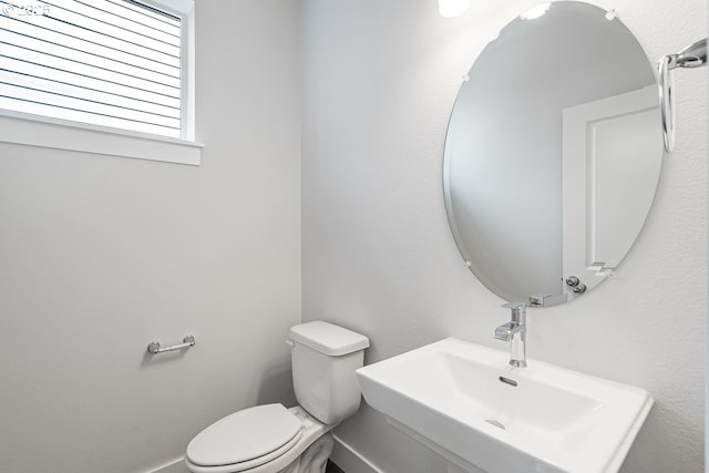 half bathroom with a sink and toilet