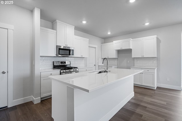 kitchen with dark wood-style floors, a sink, recessed lighting, and appliances with stainless steel finishes
