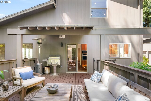 back of property featuring a deck and outdoor lounge area