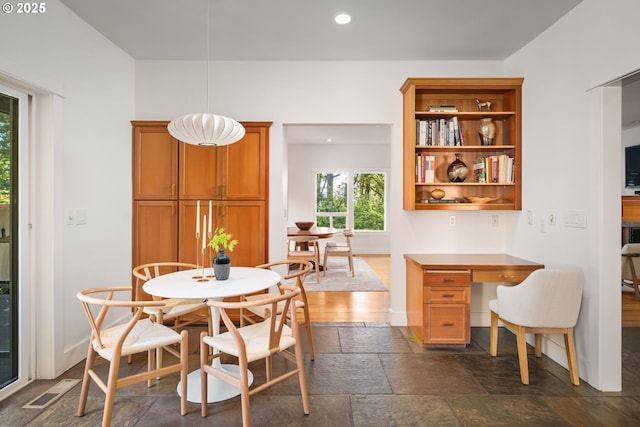 dining area with stone tile floors, recessed lighting, and baseboards
