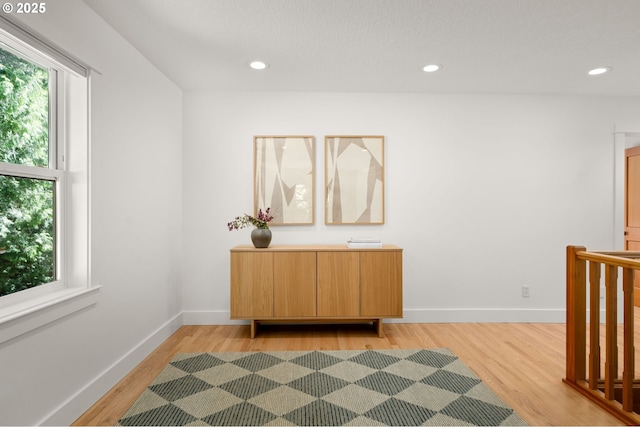 interior space featuring light wood finished floors, recessed lighting, and baseboards