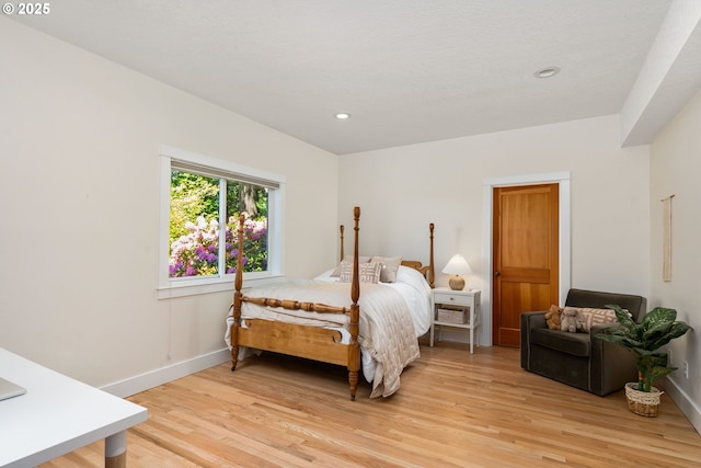 bedroom with light wood finished floors, baseboards, and recessed lighting