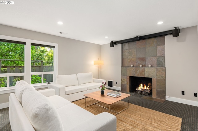 carpeted living room featuring a barn door, recessed lighting, baseboards, and a fireplace
