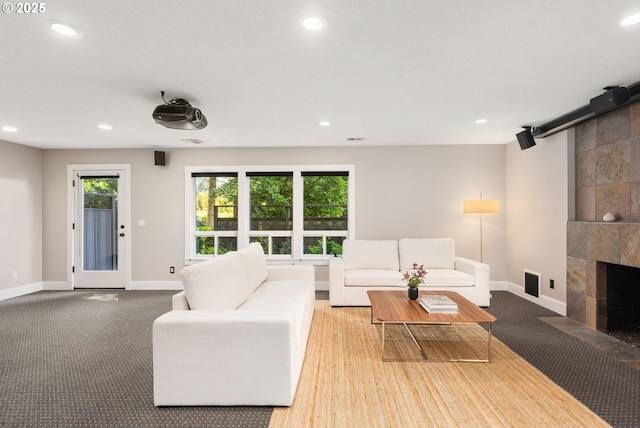 carpeted living room featuring baseboards, recessed lighting, and a fireplace