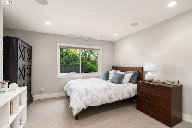 bedroom with light carpet, recessed lighting, and baseboards