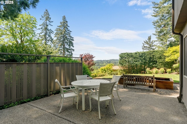 view of patio / terrace featuring outdoor dining area and fence