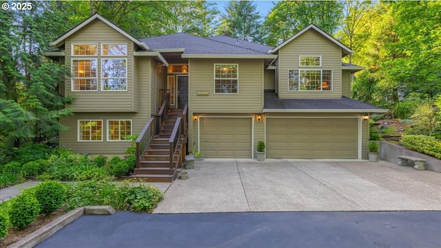7445 SW Canyon Dr, Portland, OR 97225 - view of front of house with a garage, stairs, driveway, and a shingled roof