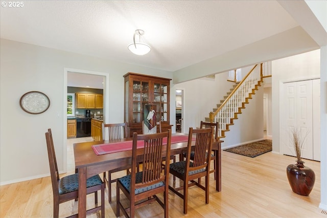 7445 SW Canyon Dr, Portland, OR 97225 - dining space with light wood finished floors, stairway, and a textured ceiling
