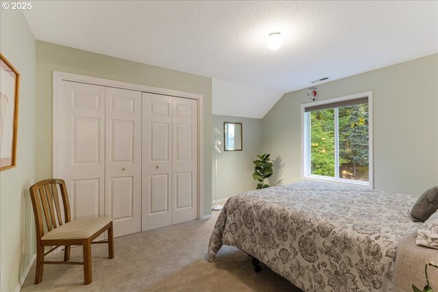 7445 SW Canyon Dr, Portland, OR 97225 - bedroom featuring light colored carpet, a closet, lofted ceiling, and a textured ceiling