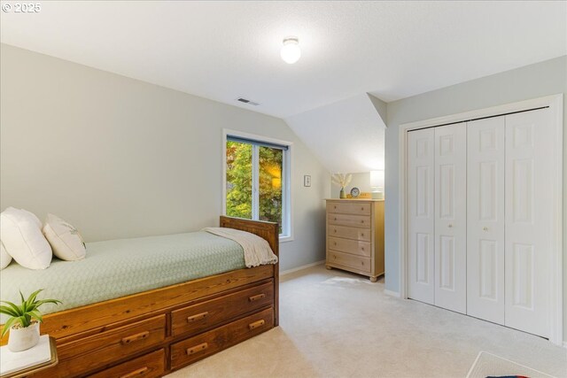 7445 SW Canyon Dr, Portland, OR 97225 - bedroom featuring light colored carpet, vaulted ceiling, and a closet