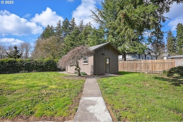 view of outbuilding with fence and an outbuilding