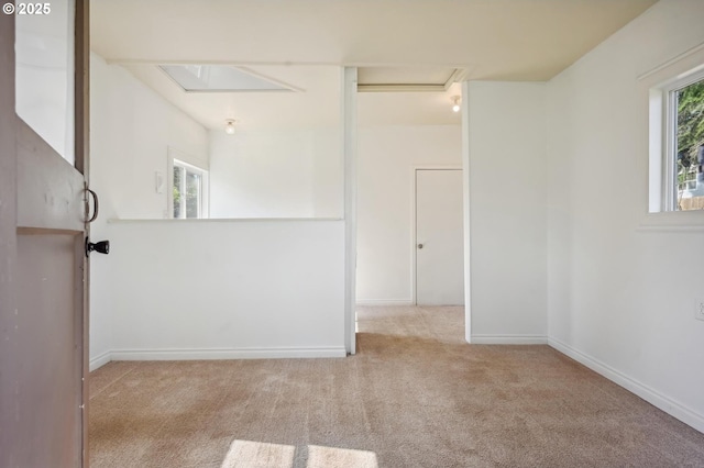 spare room with carpet and baseboards