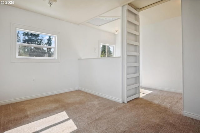 carpeted empty room with baseboards