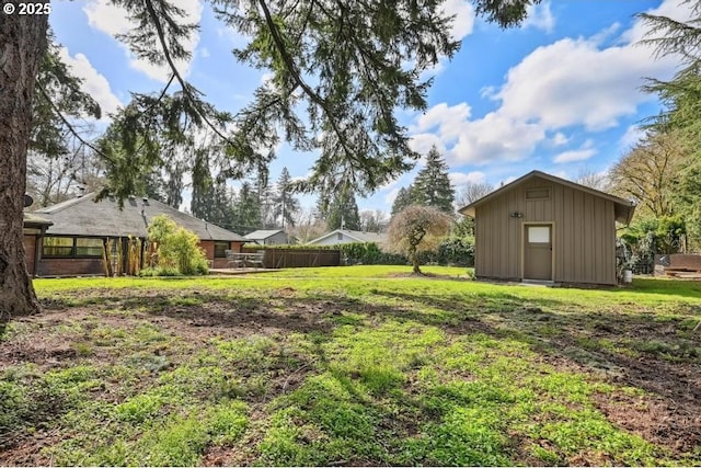 view of yard featuring fence and an outdoor structure