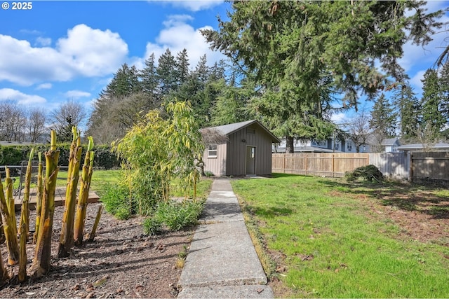 view of yard with an outbuilding, a storage shed, and fence