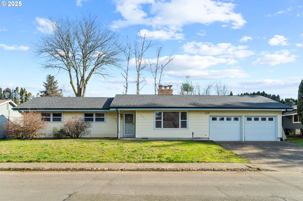 single story home featuring a garage and a front yard