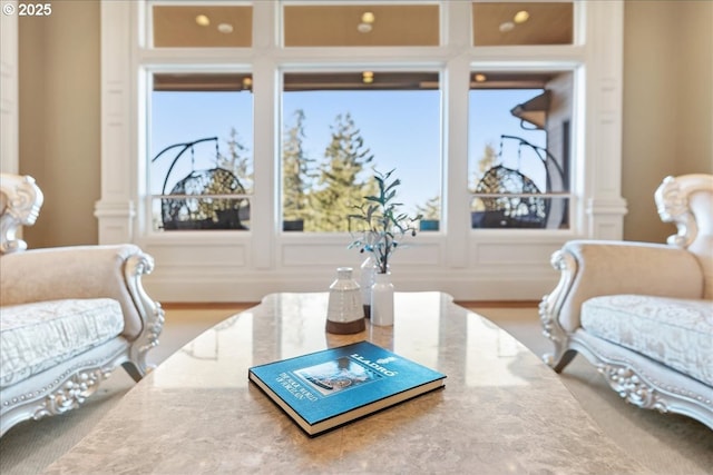 sitting room featuring plenty of natural light and a decorative wall