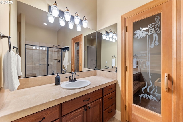 bathroom with vanity and a shower with shower door