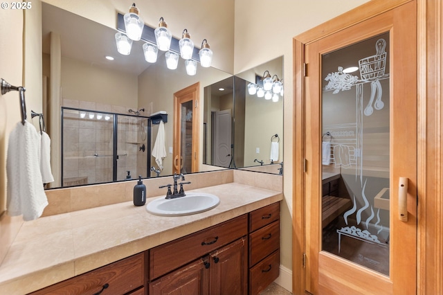 bathroom featuring vanity, a sauna, a shower stall, and recessed lighting