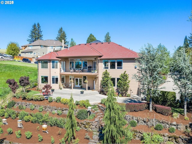 back of house featuring a balcony and a patio area