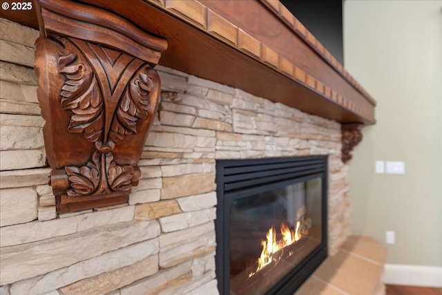 interior details featuring a stone fireplace