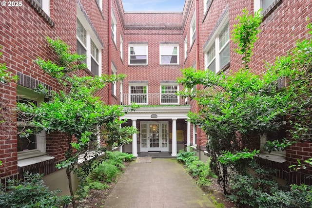 property entrance with french doors and brick siding