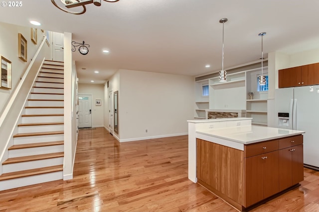 8006 SE Sporri Ln, Milwaukie, OR 97267 - kitchen featuring white refrigerator with ice dispenser, a center island, light wood-style flooring, recessed lighting, and hanging light fixtures