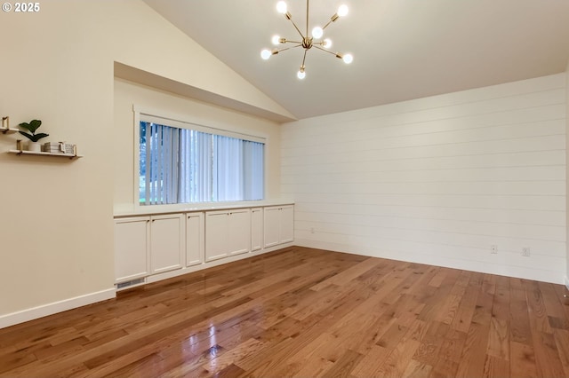 8006 SE Sporri Ln, Milwaukie, OR 97267 - empty room with a chandelier, light wood finished floors, and lofted ceiling
