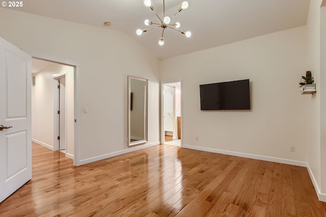 8006 SE Sporri Ln, Milwaukie, OR 97267 - unfurnished living room with a chandelier, light wood-type flooring, baseboards, and lofted ceiling