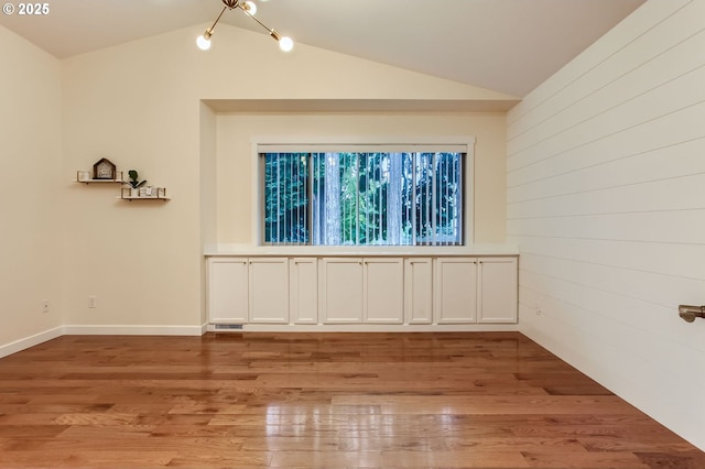 8006 SE Sporri Ln, Milwaukie, OR 97267 - empty room with lofted ceiling, light wood-style flooring, and baseboards