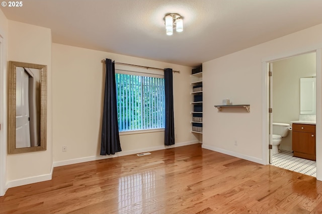 8006 SE Sporri Ln, Milwaukie, OR 97267 - unfurnished bedroom featuring light wood-style floors, baseboards, and ensuite bathroom