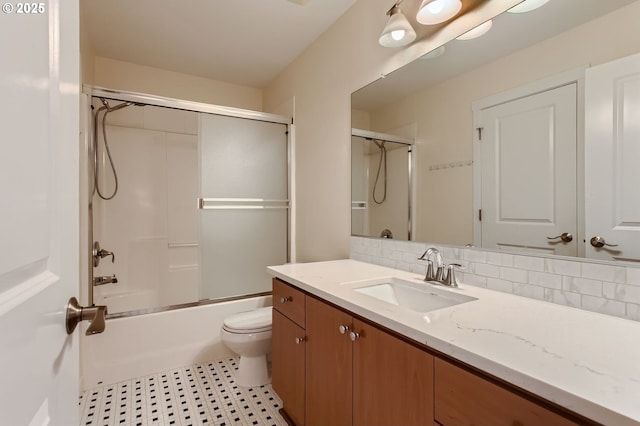 8006 SE Sporri Ln, Milwaukie, OR 97267 - bathroom featuring vanity, toilet, and bath / shower combo with glass door