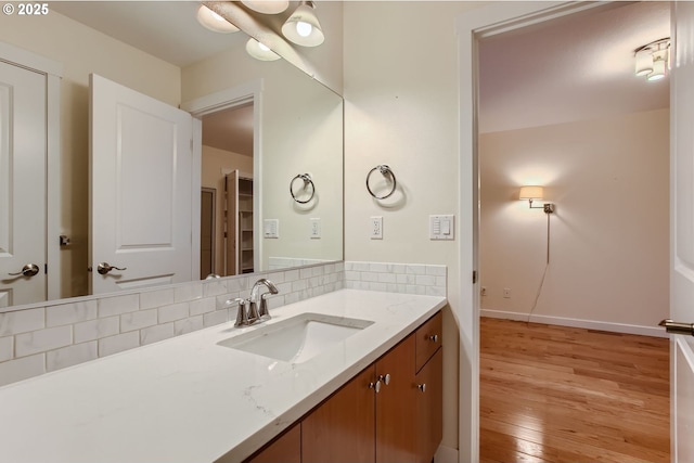 8006 SE Sporri Ln, Milwaukie, OR 97267 - bathroom with wood finished floors, decorative backsplash, vanity, and baseboards