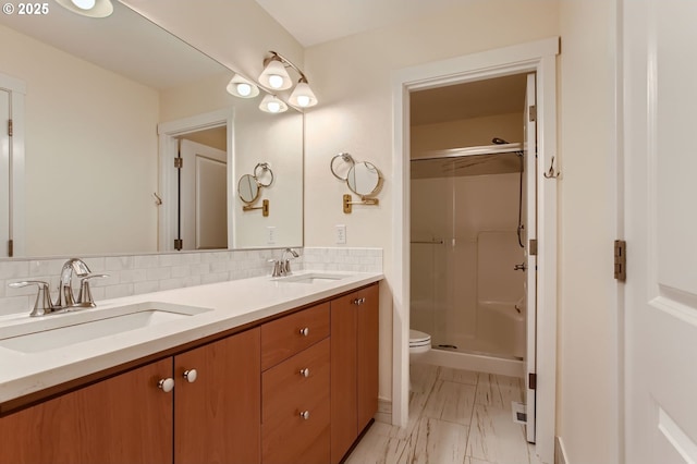 8006 SE Sporri Ln, Milwaukie, OR 97267 - bathroom with toilet, marble look tile flooring, double vanity, a stall shower, and decorative backsplash