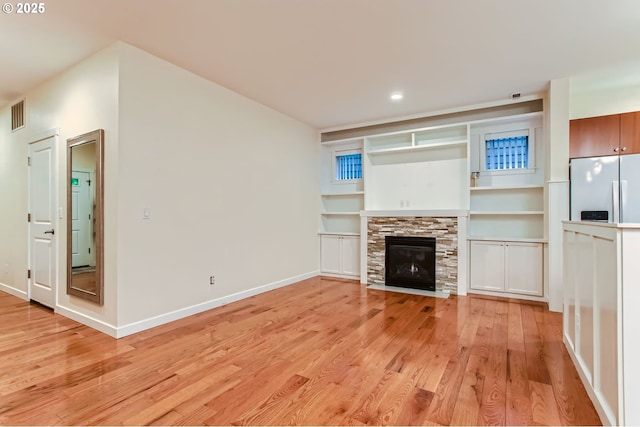8006 SE Sporri Ln, Milwaukie, OR 97267 - unfurnished living room featuring light wood-style flooring, baseboards, a fireplace, and recessed lighting