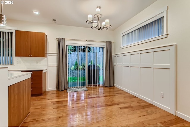 8006 SE Sporri Ln, Milwaukie, OR 97267 - unfurnished dining area with a chandelier, light wood-type flooring, recessed lighting, and baseboards
