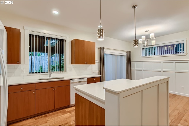 8006 SE Sporri Ln, Milwaukie, OR 97267 - kitchen with dishwasher, a sink, decorative backsplash, brown cabinetry, and recessed lighting