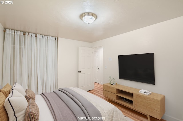 bedroom featuring wood finished floors